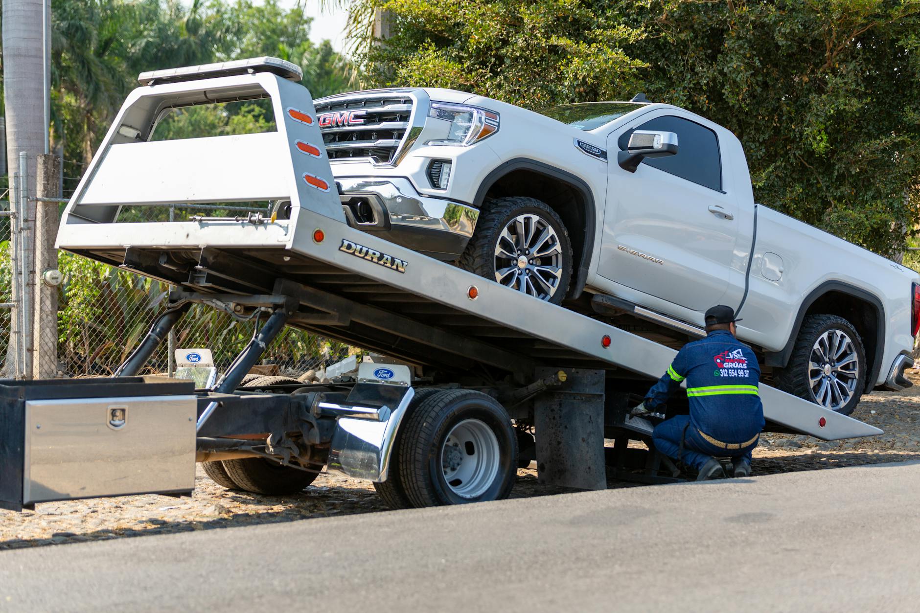 A clean, modern Cuyahoga Towing flatbed truck ready for dispatch in Canton, Ohio.