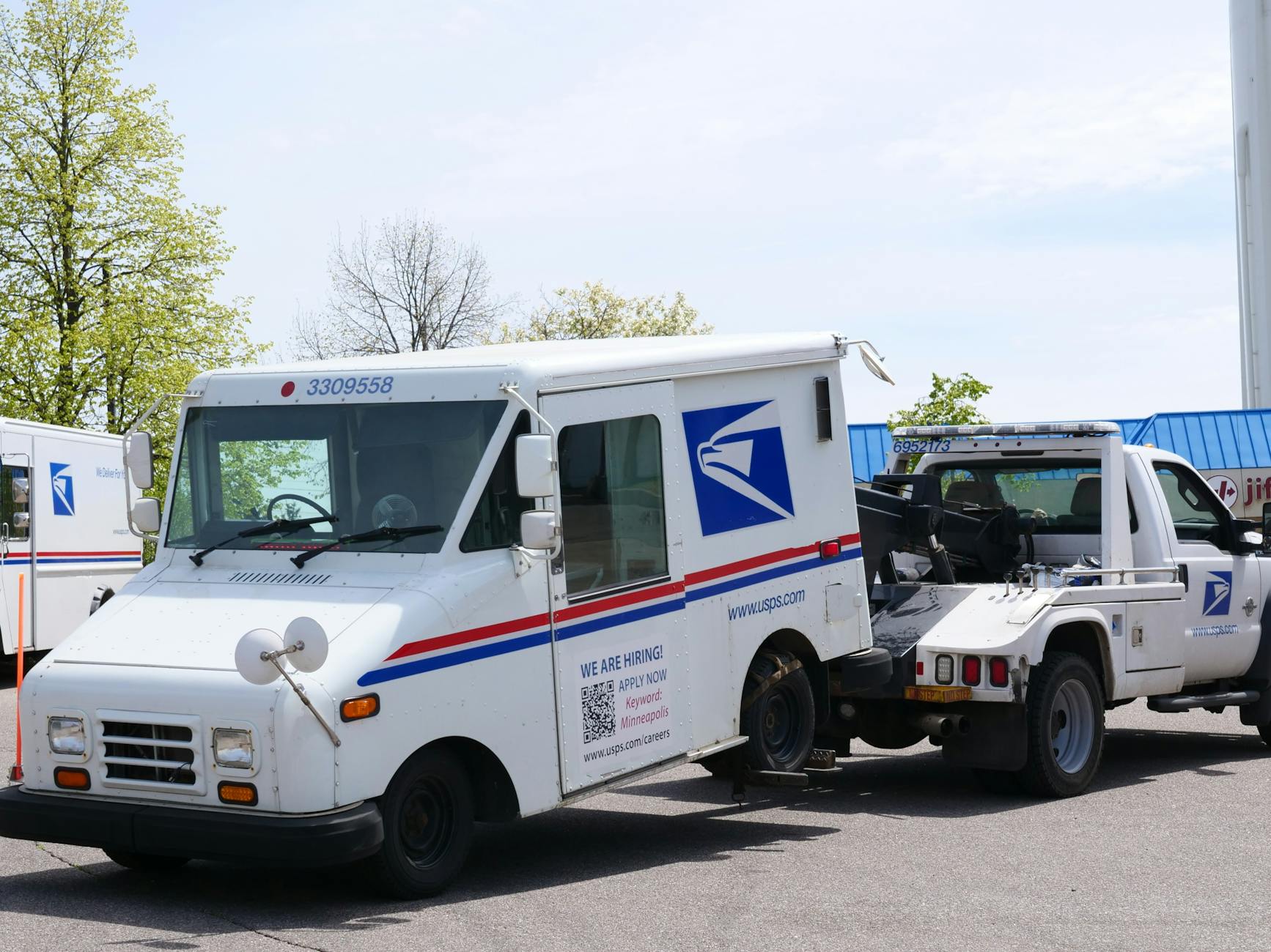 A professional flatbed tow truck parked safely on a residential street in Massillon, Ohio, ready for service.
